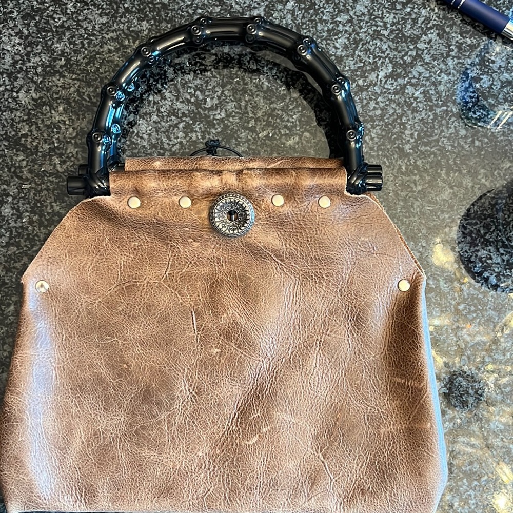 Distressed brown leather clutch with elastic closure